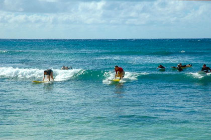 Students surfing at Kiahuna Plantation in Poipu